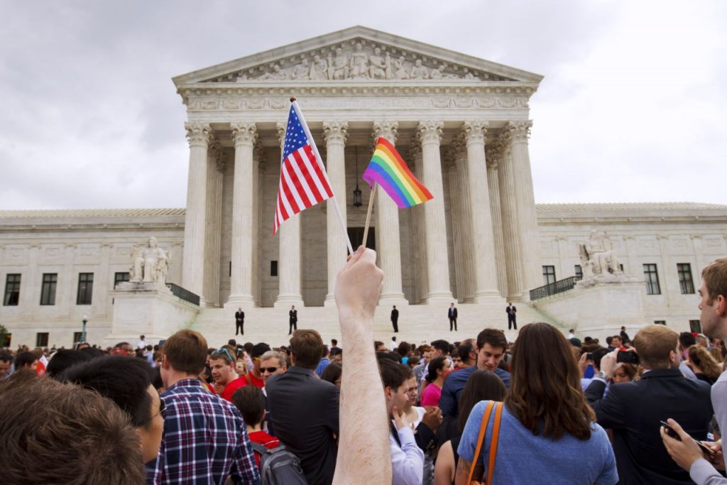 The crowd celebrates outside of the Supreme Court in Washington, Friday June 26, 2015, after the court declared that same-sex couples have a right to marry anywhere in the US. (AP Photo/Jacquelyn Martin)