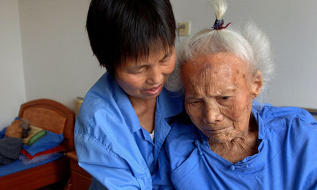 Nurse takes care of elderly woman