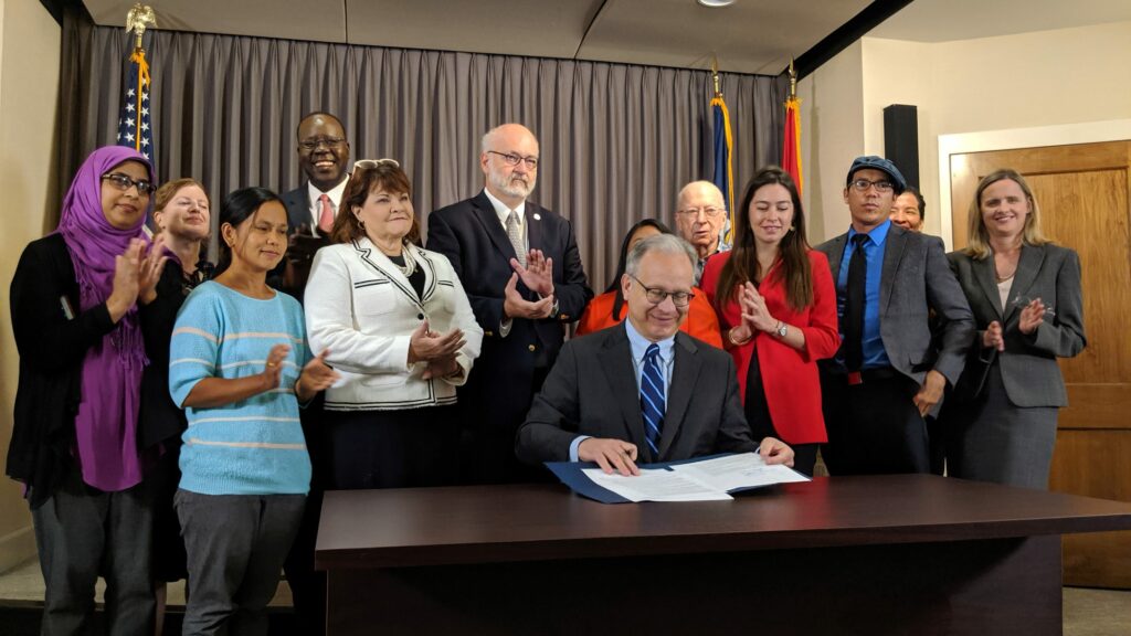 Mayor Briley signs the executive order denouncing TN's anti-sanctuary city law (photo credit: The Tennessean)