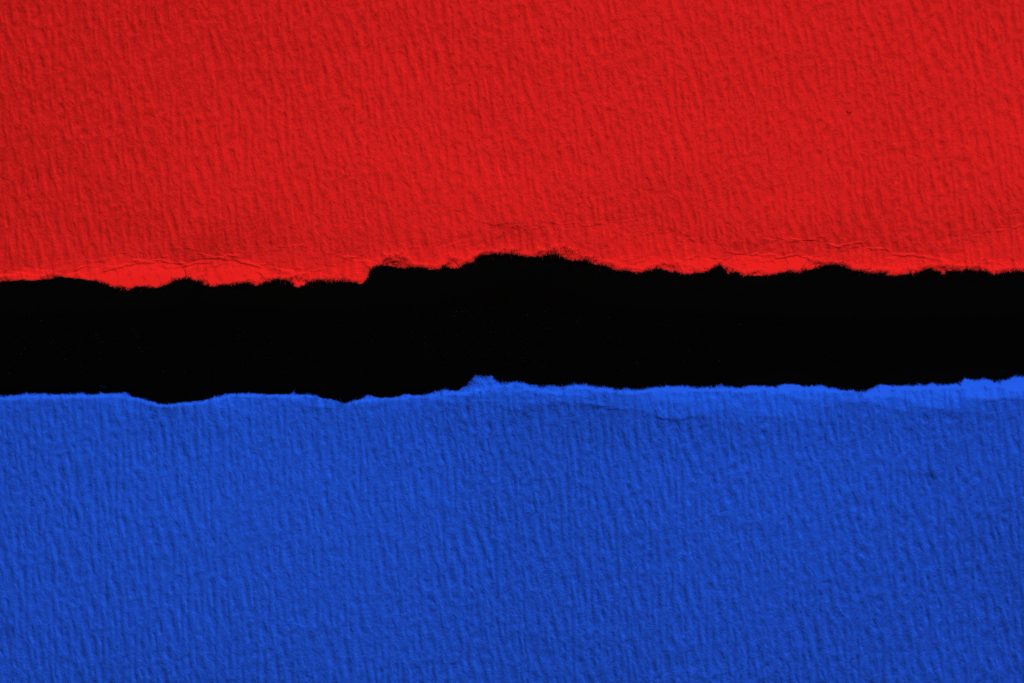 Blue vs red torn paper with black  space for text